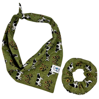 Green bandana with black and white dog pattern on a white background