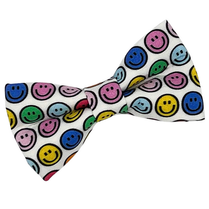 Colorful smiley face patterned bow tie on a white background
