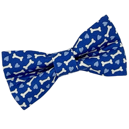 Blue bow tie with bone and heart pattern on a white background